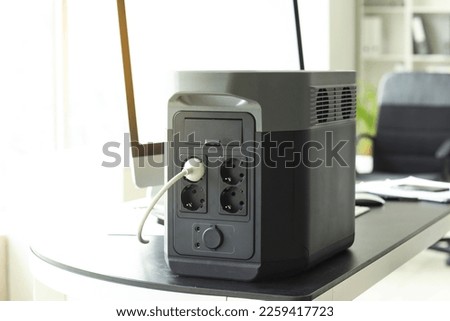 Portable power station on table in office