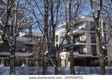 Park in winter, modern apartments on second plan