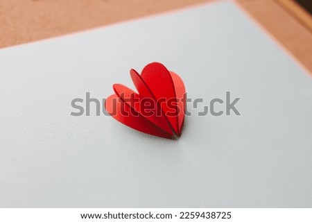 Handmade paper cutout heart for valentine's day on blue background. Backstage. 