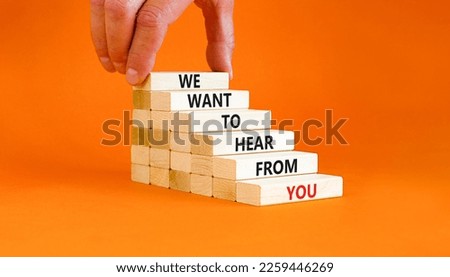 Support symbol. Concept words We want to hear from you on wooden blocks. Beautiful orange table orange background. Businessman hand. Business support we want to hear from you concept. Copy space.