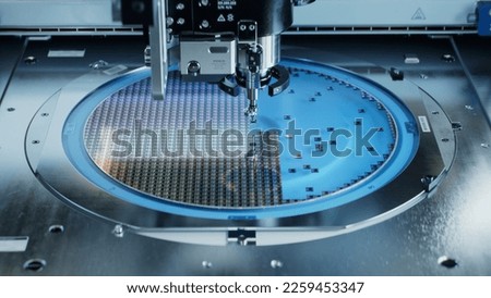 Semiconductor Packaging Process. Computer Chips are being Extracted by a Pick and Place Machine from Semiconductor Wafer and Attached to Substrate. Computer Chip Manufacturing at Factory Royalty-Free Stock Photo #2259453347