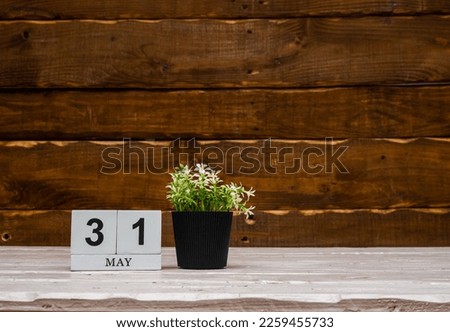 May calendar with number  31. Planner copy space on a wooden brown background. March number icon. Place for text background calendar