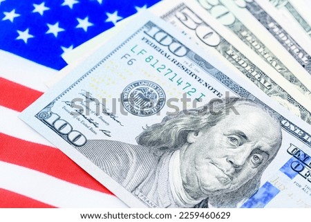 Safe-haven currency for investment, financial concept : United States of America flag with $100 bills. Depicting the most often used asset for central bank reserves or global money for use worldwide. Royalty-Free Stock Photo #2259460629