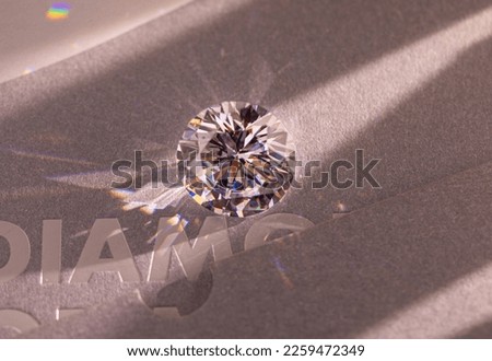 Close up of a pare of blue and white diamonds of different cuts with shadows. Royalty-Free Stock Photo #2259472349