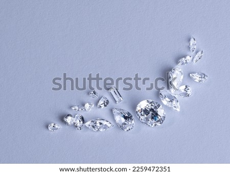 Close up of a pare of blue and white diamonds of different cuts with shadows. Royalty-Free Stock Photo #2259472351