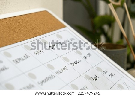 Monthly PLANNER filled with appointments and plans for next month. Busy month schedule. Magnetic board with the days of the month. Place to enter important matters schedule. Concept for business