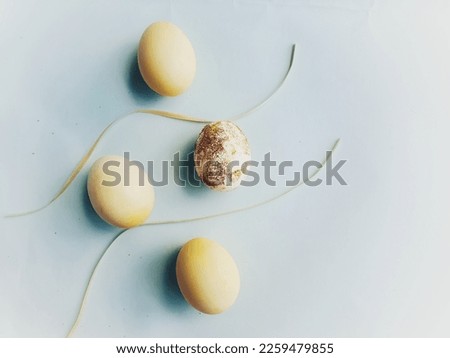  yellow eggs representing easter and with ribbons and blue background