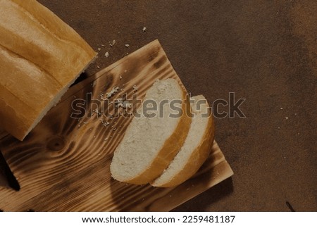 Pictured is white bread on a kitchen board with cut slices.