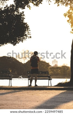 man waiting to take pictures of sunset