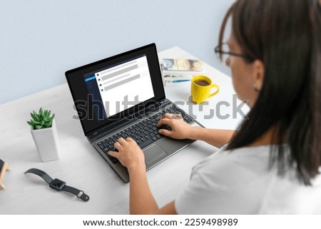 Woman using a laptop computer for work, with an Chat AI interface visible on the screen. Chat bot concept interface on laptop computer