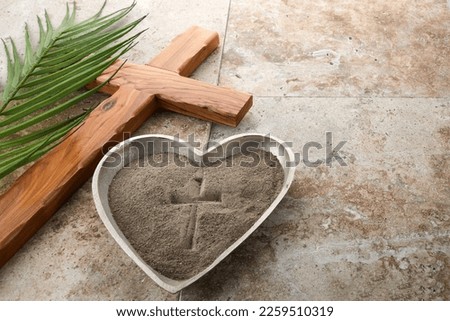 Ash wednesday, crucifix made of ash, dust as christian religion. Lent beginning Royalty-Free Stock Photo #2259510319
