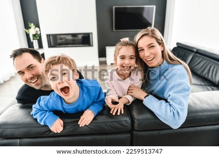 A Family of four having fun on new modern house