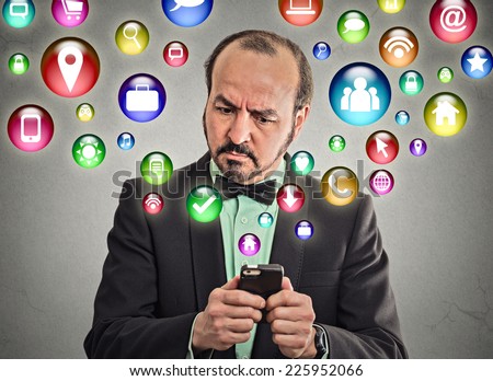 businessman corporate executive using texting on smartphone with social media mobile phone application symbols icons coming flying out of cellphone isolated grey wall background. 4g data plan concept 