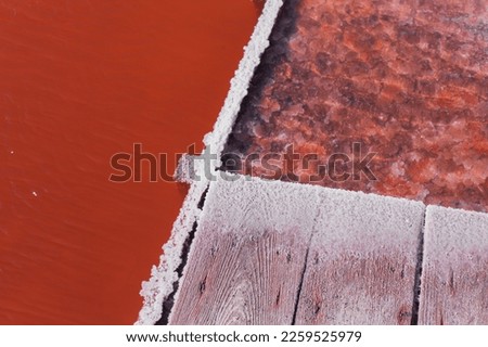 Close up pictures of pink water with salt - a process of making salt 