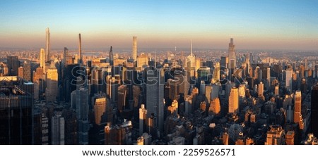 New York City aerial view of midtown Manhattan skyscrapers in warm light of sunset. An elevated view of new supertall and landmark buildings