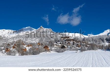 Snow covered wooden chalets of Chaillol ski resort in Ecrins National Park (Champsaur region) Hautes-Alpes (Alps), France Royalty-Free Stock Photo #2259526575
