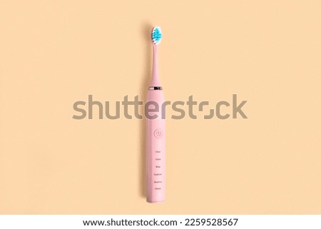 Electric Toothbrush. Top View, Flat Lay, Copy Space. Dental Care Supplies on Beige Pastel Studio Background. Oral Hygiene, Gum Health, Healthy Teeth. Modern Dental Ultrasonic Vibration Tooth Brush.