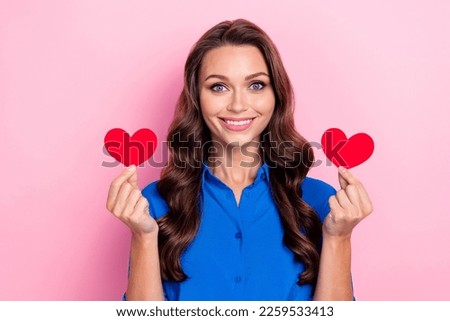 Photo of pretty cute positive lady wear blue trendy clothes showing postcards greetings isolated on pink color background