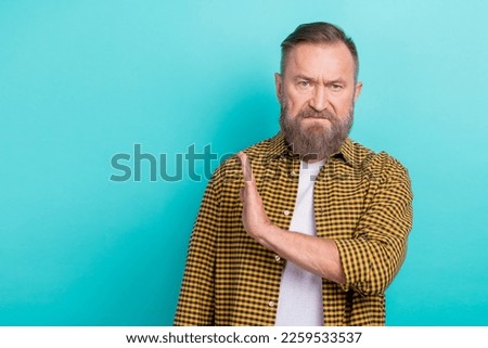 Photo of unhappy upset man wear stylish clothes arm demonstrate stop sign refuse rejection empty space isolated on cyan color background