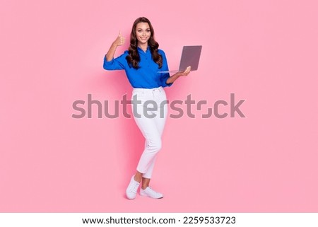 Full length cadre of professional it worker manager administrator remote recruiter thumb up hold new laptop isolated on pink color background