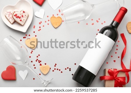 Frame made of cookies, wine and glasses on light background, closeup. Valentines Day celebration