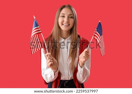 Beautiful woman with USA flags on red background