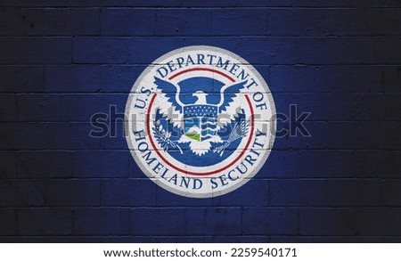 Picture of a the flag of the Department of Homeland Security painted on a wall