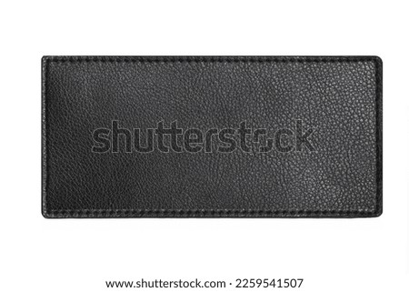 Black leather belt strap closeup isolated on white. Black stitched leather seam frame label tag isolated on white. Empty copy space fashion background. Textile frame cutout. Royalty-Free Stock Photo #2259541507