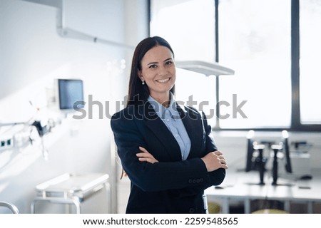 Portrait of young woman director in hospital room. Royalty-Free Stock Photo #2259548565