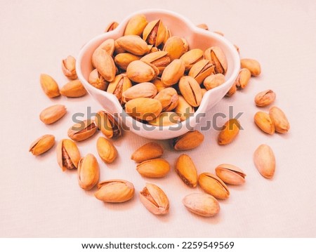 Salted pistachios nut dry fruit food roasted with cracked shell pistachio in a bowl pista closeup pistacia vera pistache pistazie view image picture stock photo