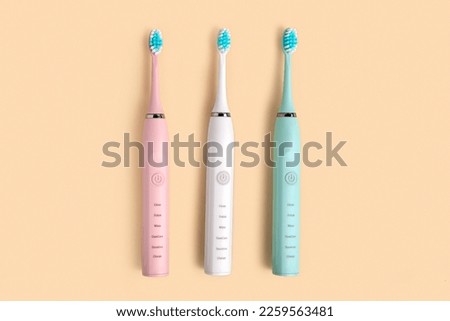 Electric Toothbrush. Top View, Flat Lay, Copy Space. Dental Care Supplies on Beige Pastel Studio Background. Oral Hygiene, Gum Health, Healthy Teeth. Modern Dental Ultrasonic Vibration Tooth Brush Set