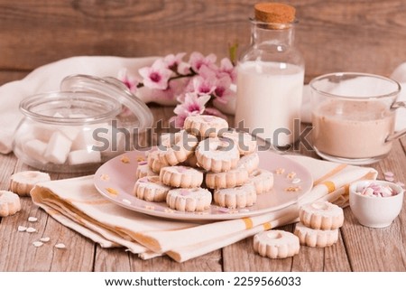 Canestrelli biscuits with icing sugar on pink dish.  Royalty-Free Stock Photo #2259566033