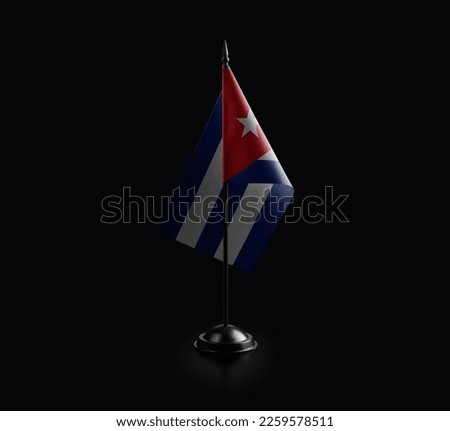 Small national flag of the Cuba on a black background.