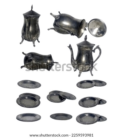 Iron old teapot and saucers with age spots on a white background.