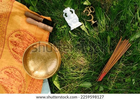 Layout figurine Trishakti Yantra, Ganesha, incense sticks, singing bowl for yoga and meditation on a herbal background.Concept of positive energy and protection from bad luck,accessory for meditation.