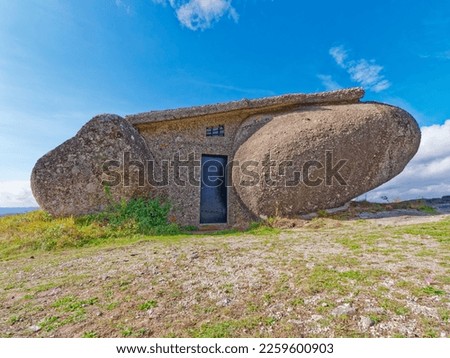 Boulder house or Casa do Penedo, a house built between huge rocks on top of a mountain in Fafe, Portugal. Usually considered one of the strangest houses in the world.  Royalty-Free Stock Photo #2259600903