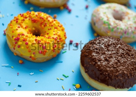 Donuts on blue background, close up, sweet background