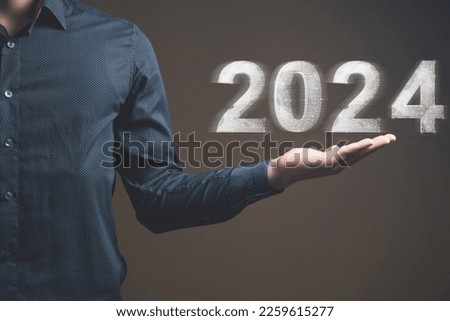2024 created from the web. Man holding in his hand
