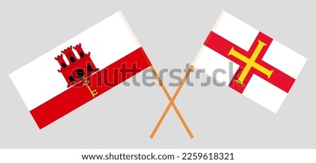 Crossed flags of Gibraltar and Bailiwick of Guernsey. Official colors. Correct proportion. Vector illustration
