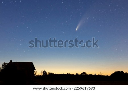 Comet NEOWISE graces the sunset above a ruined farm house in Southern Ontario, Canada, July 17, 2020. Royalty-Free Stock Photo #2259619693