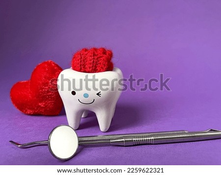 dental concept. valentine's holiday.tooth figurine and heart dental tools