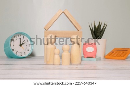 Wooden model house place on the grass. concept of real estate investment. planning savings money of coins to buy a home concept for property, mortgage and real estate investment, savings for a house.
