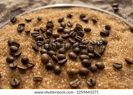 Coffee beans on brown sugar cane, background picture in brown tones