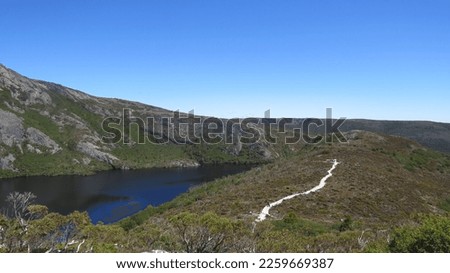                               Crater lake on the overland track, with the path. 