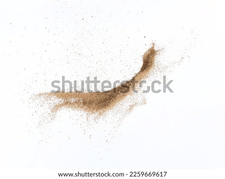 Sand flying explosion, Golden sand wave explode. Abstract sands cloud fly. Yellow colored sand splash throwing in Air. White background Isolated high speed shutter, throwing freeze stop motion Royalty-Free Stock Photo #2259669617