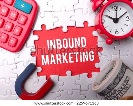 Alarm clock,magnet and banknotes with the word INBOUND MARKETING.