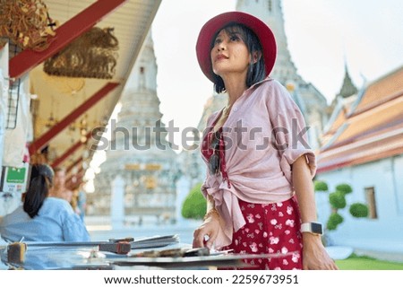 thai woman shopping for souvenirs at wat arun temple in bangkok thailand