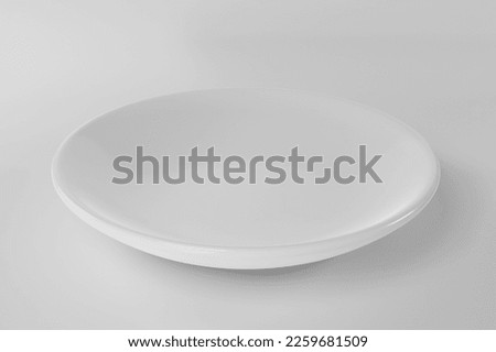 Empty white plate isolated on white background Royalty-Free Stock Photo #2259681509