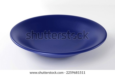 Empty dark blue plate isolated on white background Royalty-Free Stock Photo #2259681511