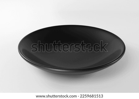 Empty black plate isolated on white background Royalty-Free Stock Photo #2259681513